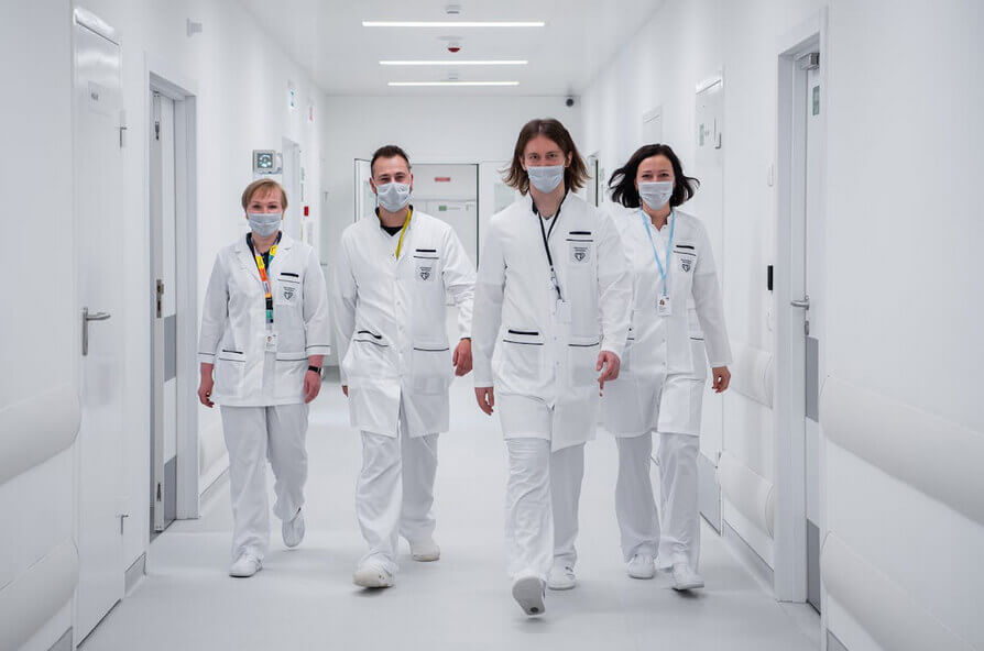 Doctors in White Coats in Hospital Corridor