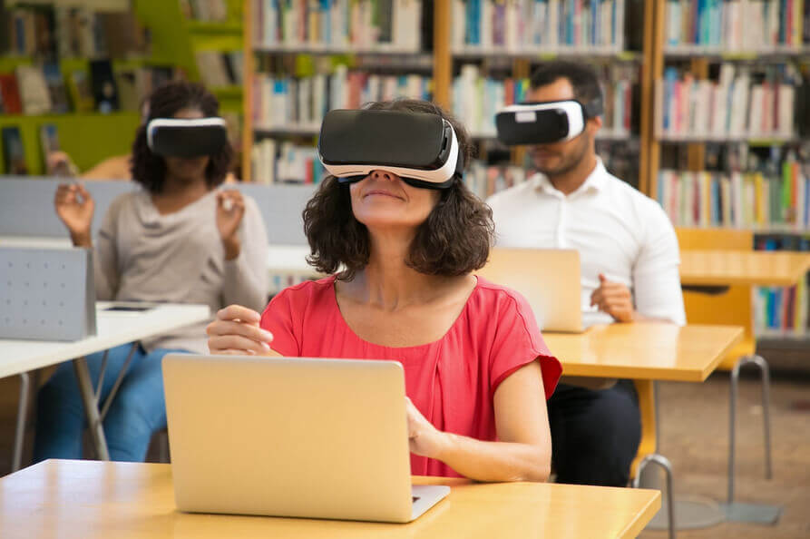 Woman using VR goggles in learning 